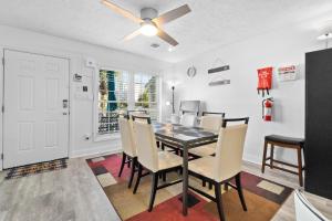 a dining room with a table and chairs and a ceiling fan at Willapye Beach House by the Sea in Navarre
