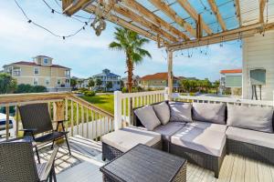 a patio with a couch and chairs on a deck at Willapye Beach House by the Sea in Navarre