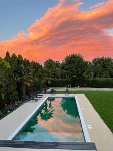 a swimming pool in a yard with a sunset at Apartment Veroeva in Rukavac