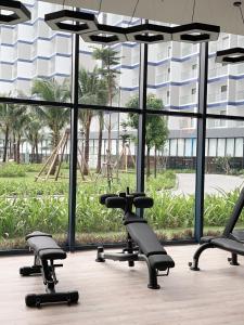 a gym with a bunch of chairs in front of a large window at The Arena Seaview Cam Ranh Home in Cam Ranh