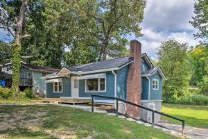 a blue house with a brick chimney at Cozy Arden Cottage, 2 Mi to Lake Julian Park! in Arden