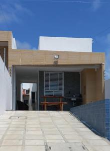 a house with a roof with a patio at Casa de Praia in Conde