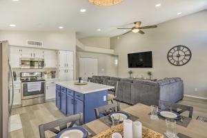 a kitchen and living room with a couch and a table at Chic Phoenix Home with Yard and Private Heated Pool! in Phoenix