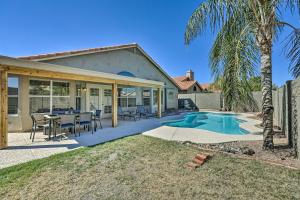 a home with a patio and a swimming pool at Chic Phoenix Home with Yard and Private Heated Pool! in Phoenix