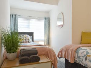 a bedroom with a bed and a window at Westways in Bridlington