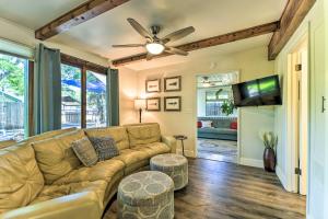 a living room with a couch and a flat screen tv at Beautiful Cody Abode with Grill - Walk to Downtown! in Cody
