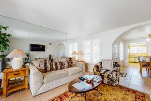 a living room with a couch and a table at Spring into Oasis Permit# 5140 in Palm Springs