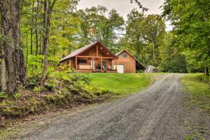 a house on the side of a dirt road at Magnificent Victory Cabin with Private Hot Tub! 
