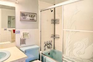 a bathroom with a blue toilet and a sink at Steps to Sand Satellite Beach Condo with Views! in Satellite Beach +22 photos