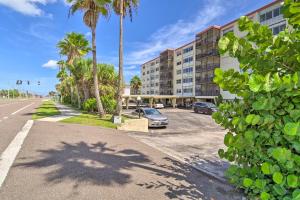 a car parked in a parking lot next to a building at Steps to Sand Satellite Beach Condo with Views! in Satellite Beach