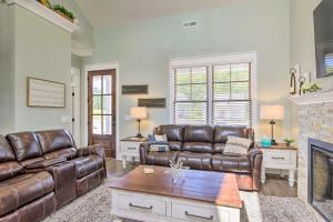 a living room with leather couches and a fireplace at Stunning Lakefront Retreat with Dock Access! in Greenwood