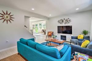 a living room with two blue couches and a fireplace at Game Room, Community Beach Pocono Home! in Albrightsville
