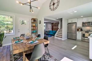 a kitchen and living room with a wooden table and chairs at Game Room, Community Beach Pocono Home! in Albrightsville