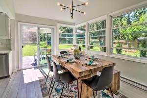 a dining room with a wooden table and chairs at Game Room, Community Beach Pocono Home! in Albrightsville