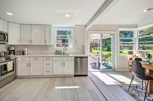 a kitchen with white cabinets and a table and chairs at Game Room, Community Beach Pocono Home! in Albrightsville