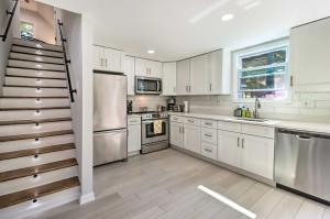 a kitchen with white cabinets and stainless steel appliances at Game Room, Community Beach Pocono Home! in Albrightsville