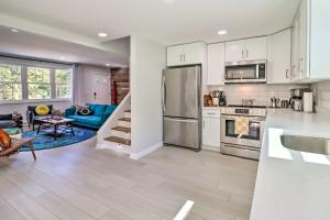 a kitchen and living room with a refrigerator and a couch at Game Room, Community Beach Pocono Home! in Albrightsville
