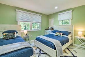 two beds in a bedroom with green walls and windows at Game Room, Community Beach Pocono Home! in Albrightsville
