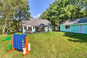 a yard with a blue house and a playground at Game Room, Community Beach Pocono Home! in Albrightsville