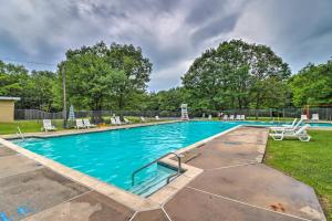 a swimming pool with chairs in a yard at Pocono Mountain Escape with Game Room Walk to Lake! in Albrightsville