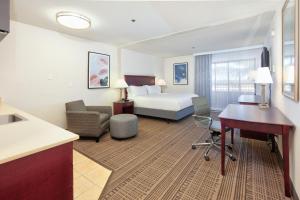 a hotel room with a bed and a desk at Holiday Inn & Suites Santa Maria, an IHG Hotel in Santa Maria