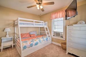 a bedroom with a bunk bed and a ceiling fan at Nautical Wildwood Apt - Walk to the Beach! in Wildwood