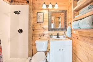 a bathroom with a toilet and a sink and a mirror at On-Site Boat Launch Gun Barrel City Lake House in Gun Barrel City +25 photos