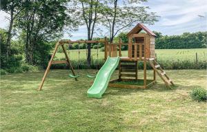 a wooden playground with a slide and a playset at Wisteria in Nanclars +11 photos