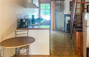 a kitchen with a table and a counter top at Wisteria in Nanclars