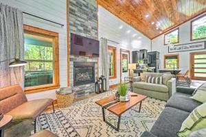 a living room filled with furniture and a fireplace at Chic Broken Bow Cabin with Hot Tub and Gas Grill! in Broken Bow