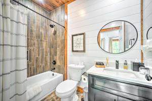 a bathroom with a tub and a toilet and a sink at Chic Broken Bow Cabin with Hot Tub and Gas Grill! in Broken Bow +24 photos