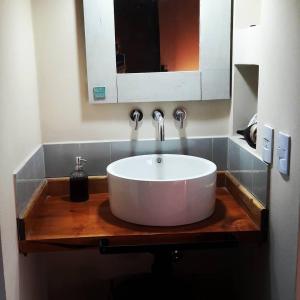 a bathroom sink with a large white bowl at Pequeña Polonia-Lodge & Cabañas in Los Reartes