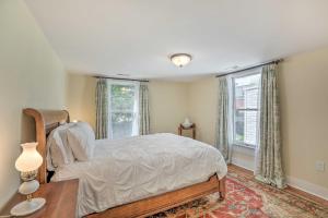 a bedroom with a bed and a table and a window at Charming Lambertville Retreat - 1 Mi to River! in Lambertville
