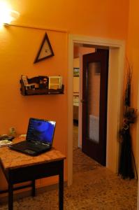 a laptop computer sitting on a table in a room at B&B Gate 52 in Pisa