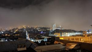 a view of a city at night with lights at Vibes Aurik in Quito