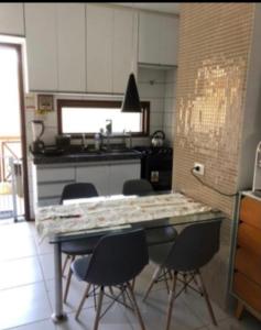 une cuisine avec une table et des chaises. dans l'établissement Flat Monte Castelo - Gravatá, à Bezerros