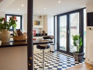 a kitchen with a black and white checkered floor at The Potting Shed in Preston Wynne