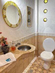 a bathroom with a sink and a toilet and a mirror at Chilcagua in Purmamarca +32 photos