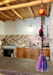 a kitchen with wooden cabinets and a counter top at Chilcagua in Purmamarca
