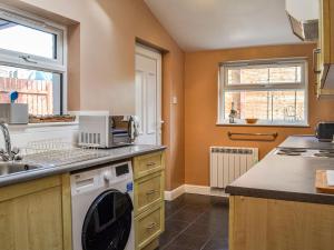 a kitchen with a sink and a dishwasher at Sunnyside in New Galloway