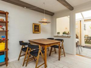 a dining room with a wooden table and chairs at 4 person holiday home in Rudk bing in Rudkøbing