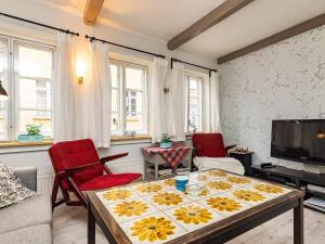 a living room with a table and chairs and a tv at 4 person holiday home in Rudk bing in Rudkøbing