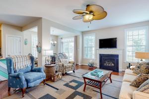 a living room with a couch and a fireplace at Millville by the Sea --- 23772 Pembroke Lane in Millville