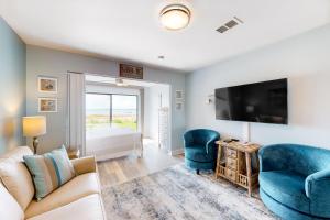 a living room with a couch and a tv at Sunset Harbor Palms 2-108 in Navarre