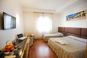 Postel nebo postele na pokoji v ubytování Hotel Minerva