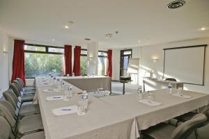 a conference room with a long table and chairs at Best Western Plus Hostellerie Du Vallon in Trouville-sur-Mer +37 photos