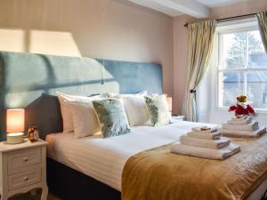 a bedroom with a bed with a teddy bear on it at Staffield Cottage in Kirkoswald