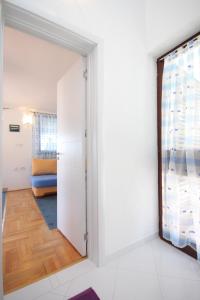 a room with a door leading to a bedroom at Apartments with a parking space Ravni, Labin - 7674 in Ravni