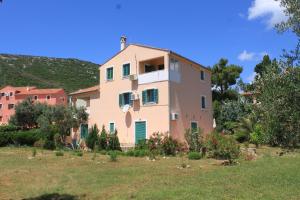 a large house in the middle of a field at Apartments with a parking space Sveti Jakov, Losinj - 8011 in Nerezine