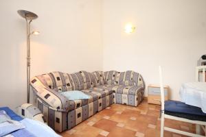 a living room with a couch and two beds at Apartments with a parking space Sveti Jakov, Losinj - 8011 in Nerezine